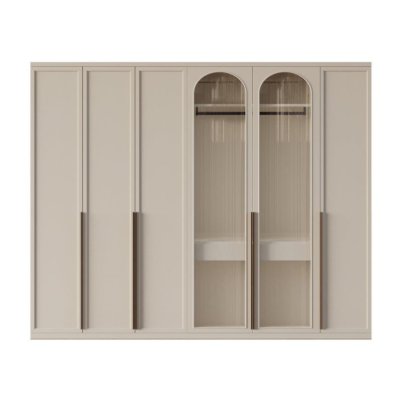 Coda Closet with off-white finish, arched ribbed glass doors, and brown metal handles for elegant storage