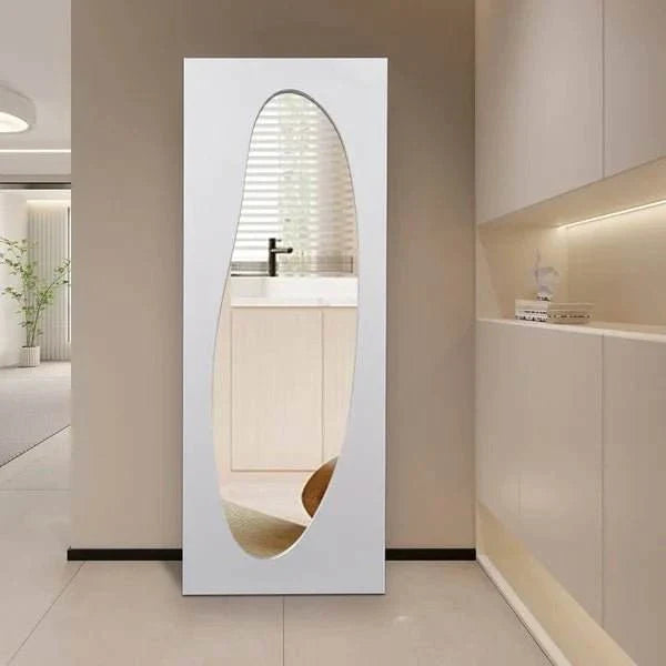 Heath Mirror with silver frame and abstract asymmetrical design in modern room
