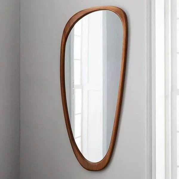 Synth Mirror with walnut wood frame and unique boho design hanging on wall