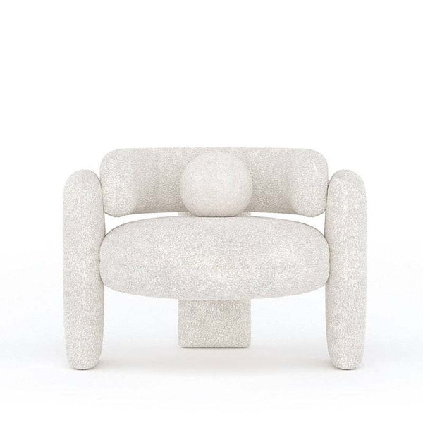 Modern white boucle Vector Armchair with curved arms, three legs, and a toss pillow.
